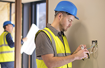 NICEIC contractor working on a light switch 