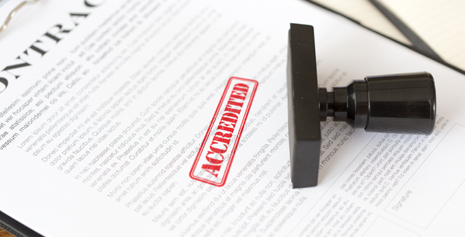 A printed contract that has been accredited and stamped with red ink.