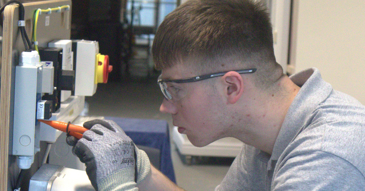 Electrical apprentice carrying out work.