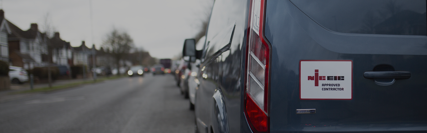 An approved NICEIC contractor’s van parked on a residential road.