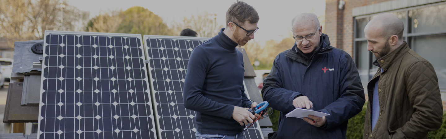 An NICEIC approved contractor explaining the user manual for the insulation of solar panels to a client at their household.