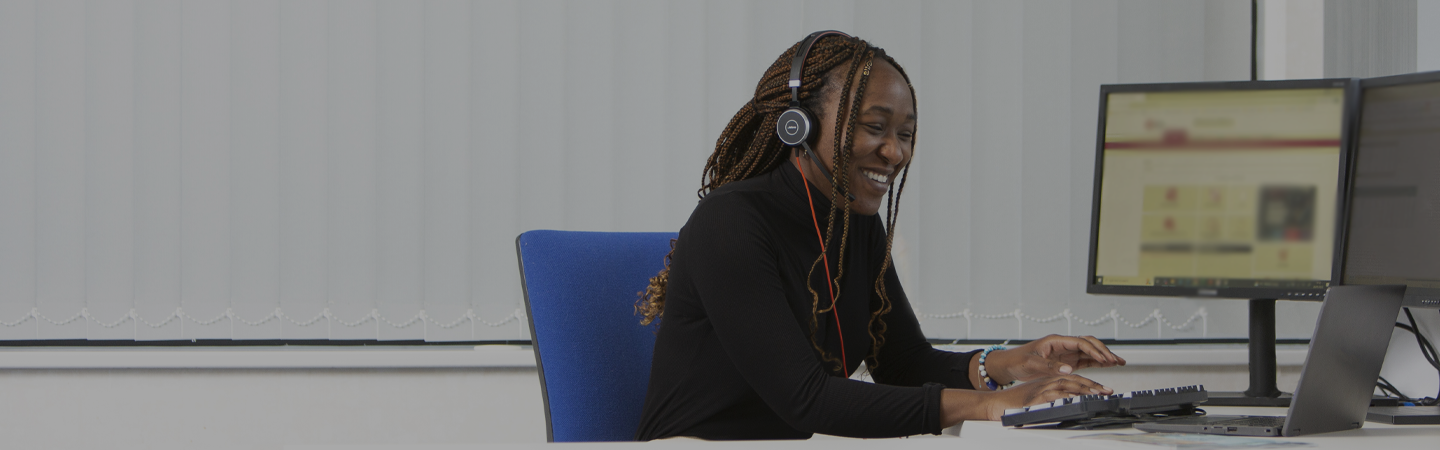 An NICEIC employee working at a computer deck at the head quarters in Dunstable