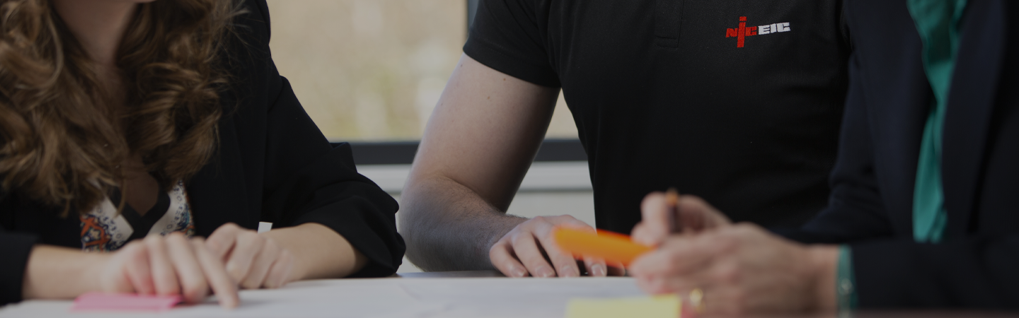 Internal teams members reviewing documents with an NICEIC approved contractor at the NICEIC head office in Warwick House, Houghton Hall Park, Dunstable.